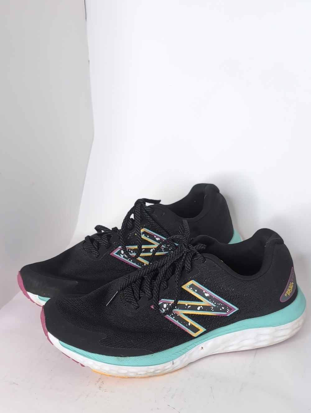 New Balance Black Running Shoes with Teal and Pink Accents